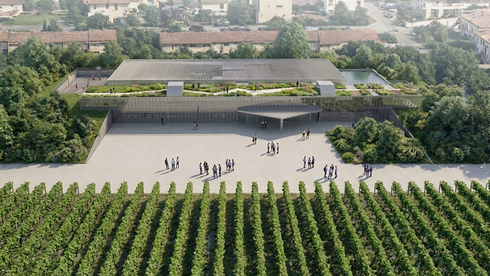Vista aerea del prospetto Sud: ingresso secondario con piazza pubblica e aule con tetto giardino circondate da vigneti e boschi.